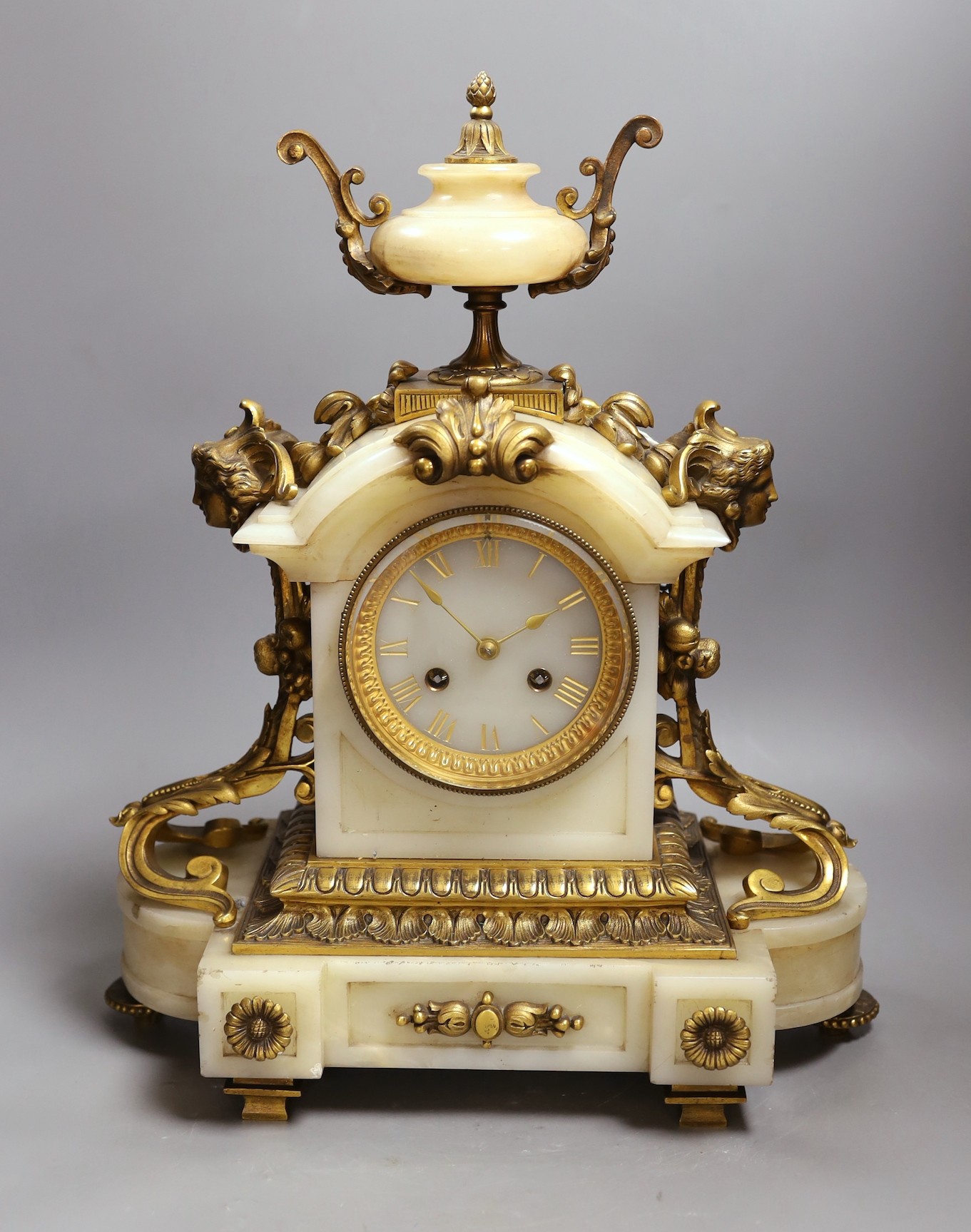 A late 19th century French ormolu mounted alabaster mantel clock. 42cm tall